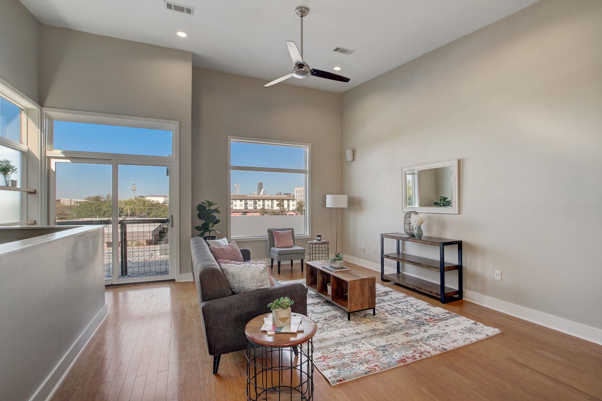 Living room with light wood finished floors, a ce