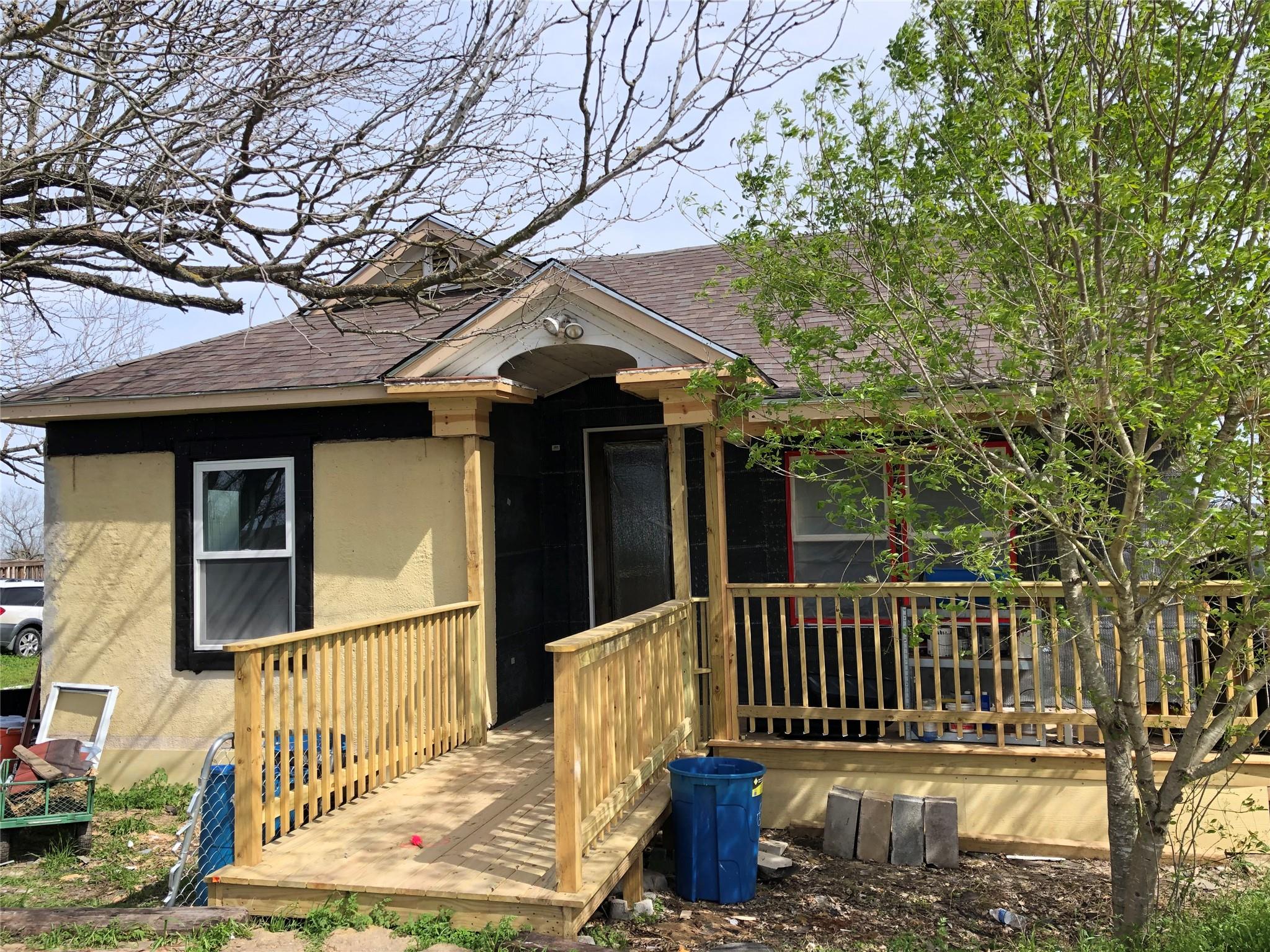 A charming cottage, featuring a welcoming porch w