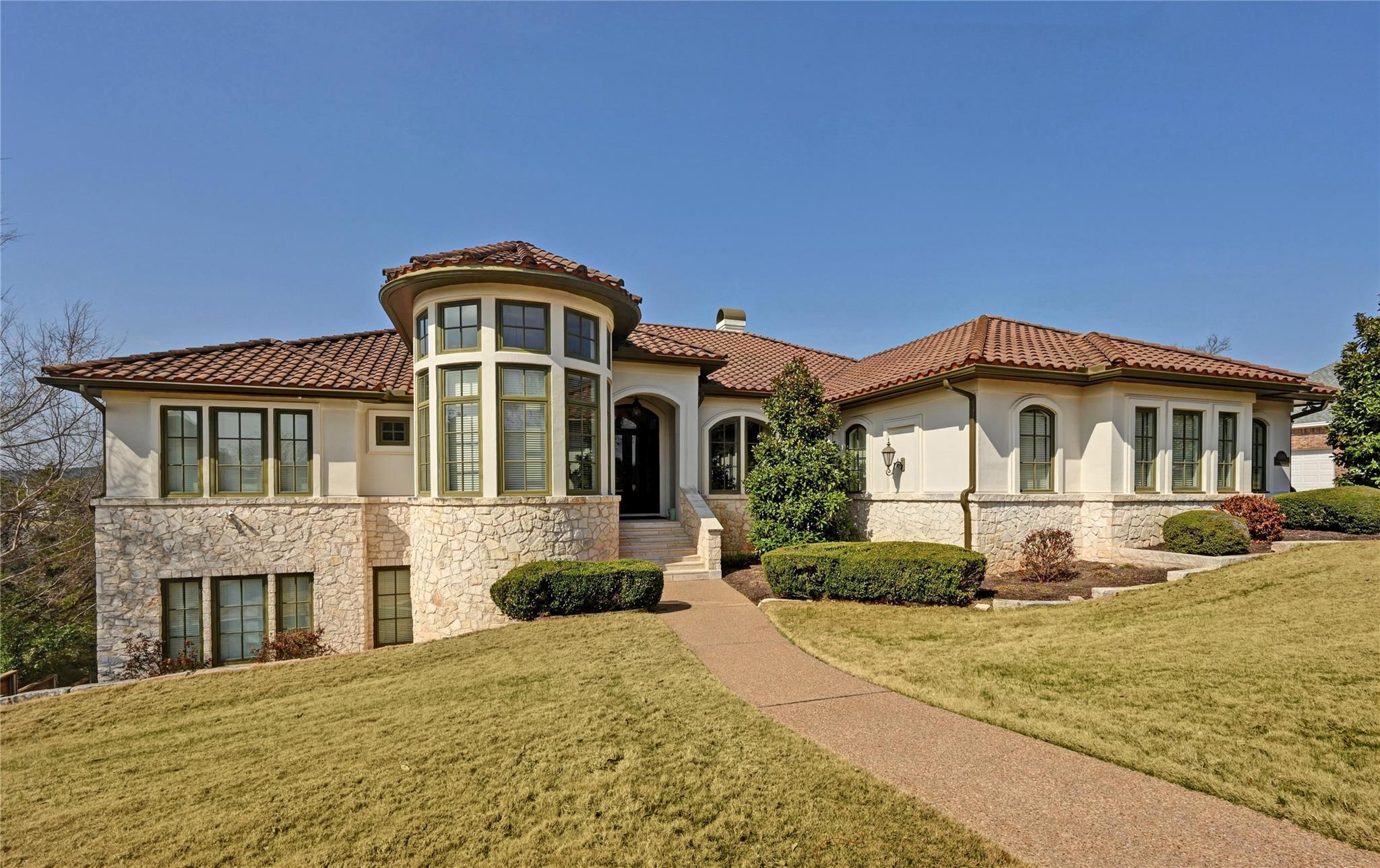 Mediterranean / spanish home with stone siding, a