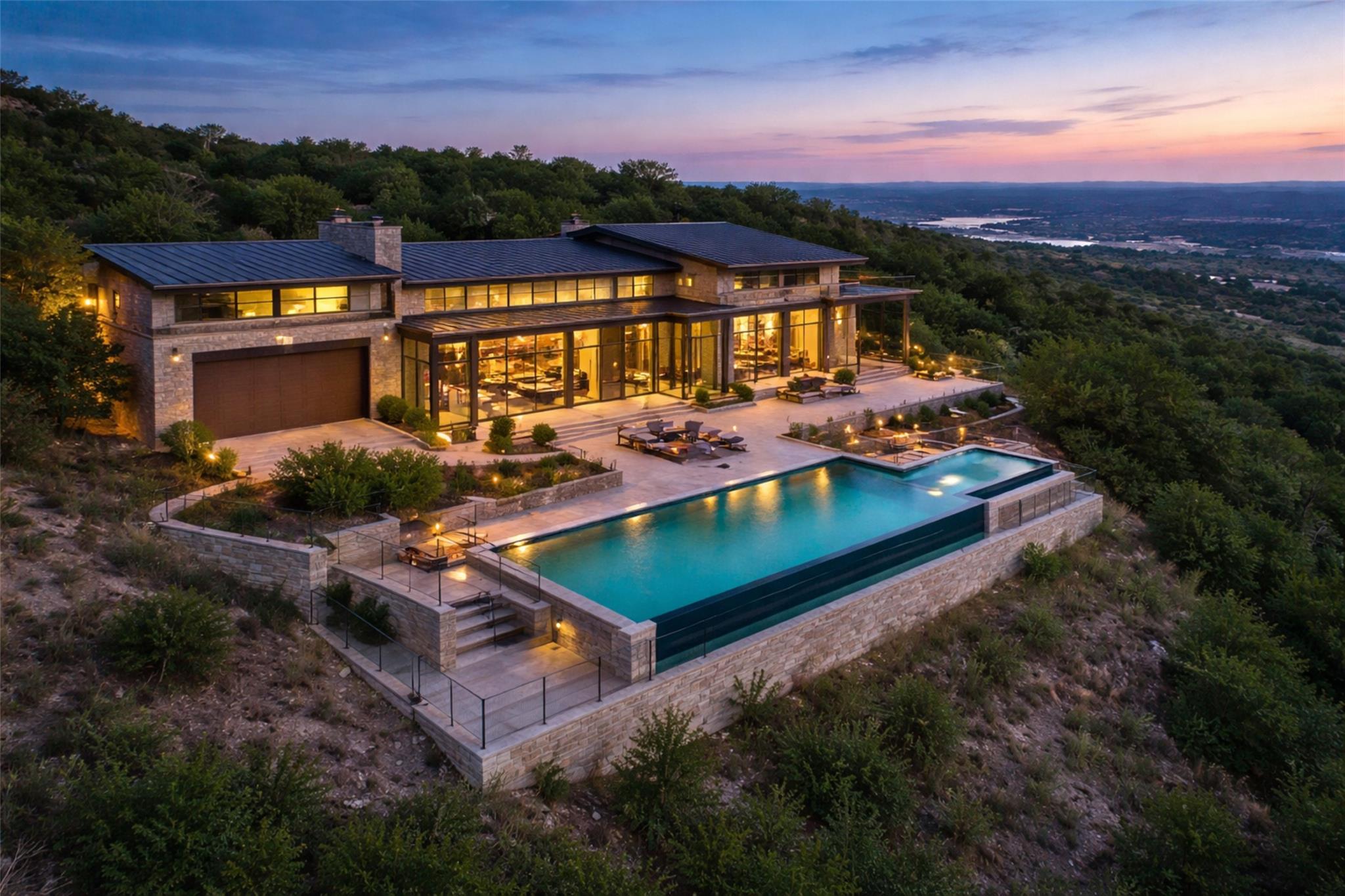 Rear view of house with a patio, stone siding, an