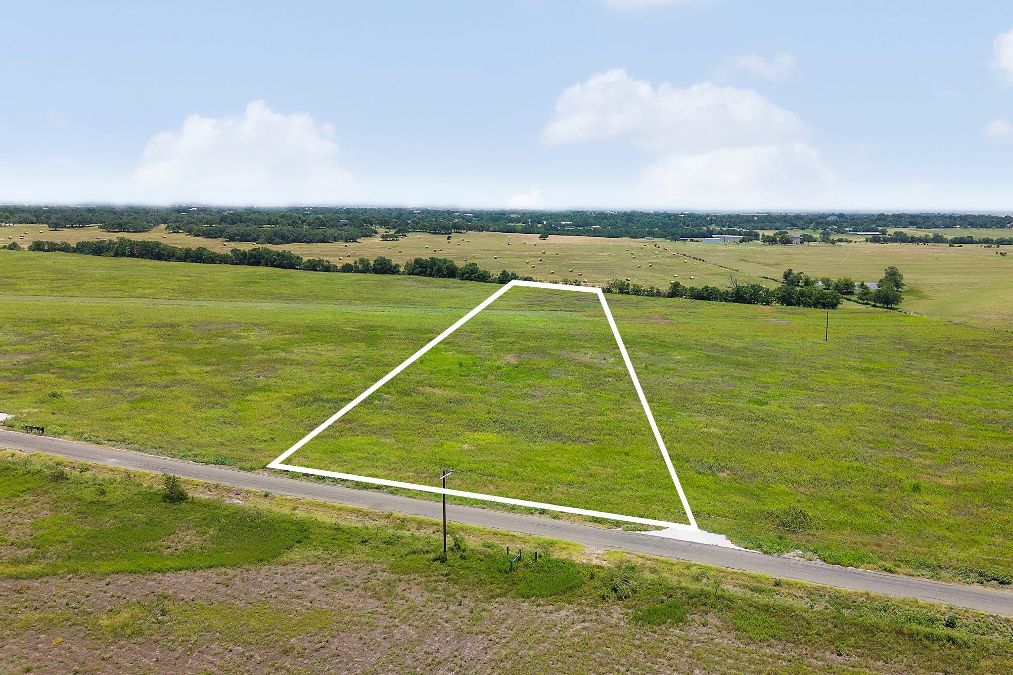 A spacious, verdant lot awaits your vision, perfe