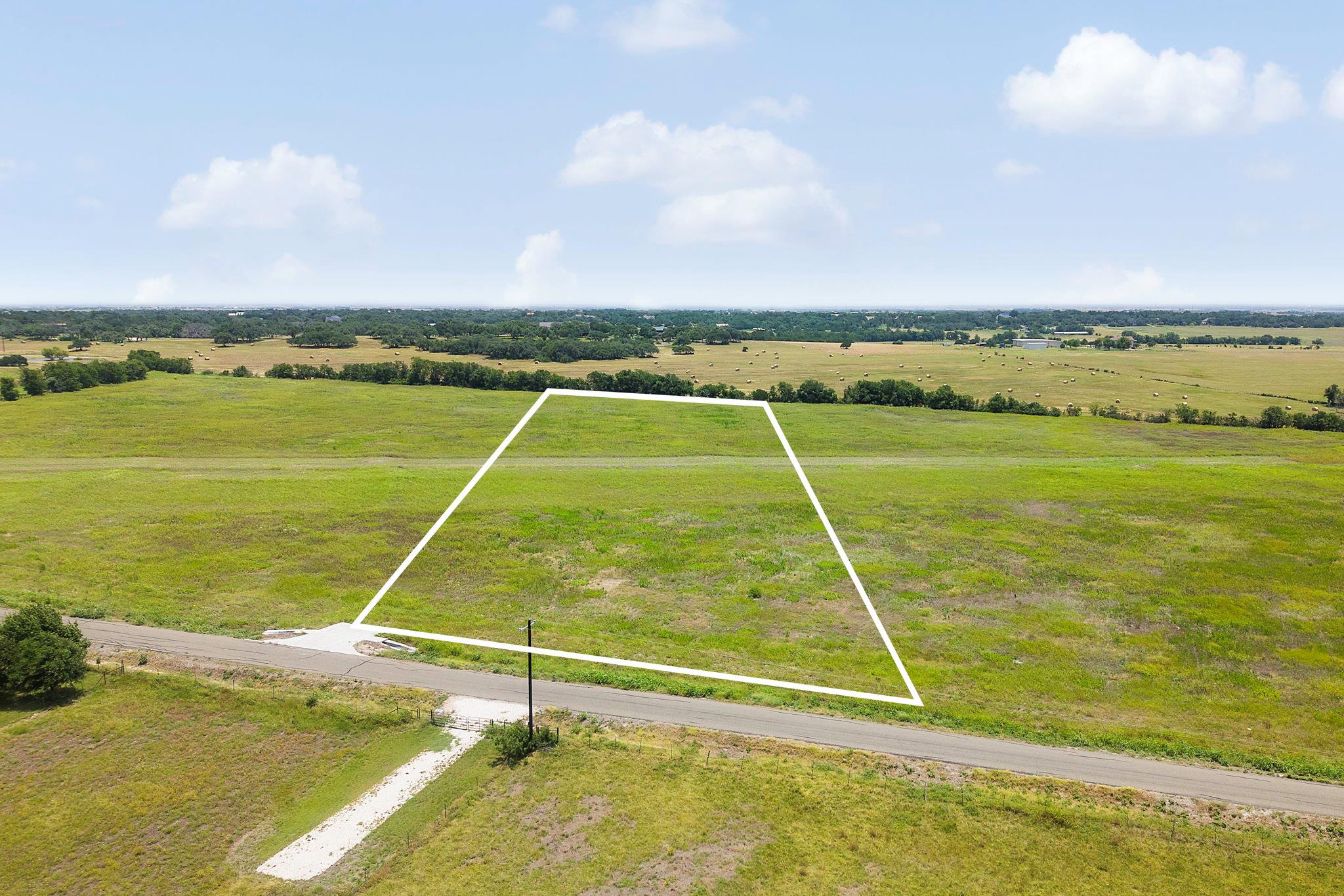 A spacious, verdant lot awaits your vision, perfe