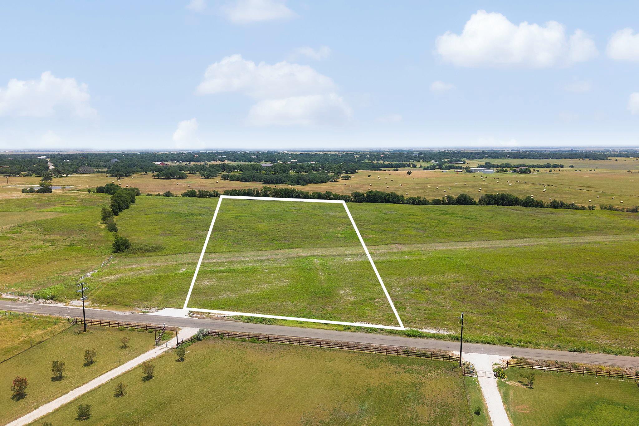 A spacious, verdant lot awaits your vision, perfe