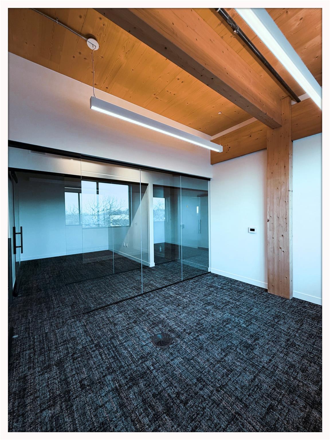 Unfurnished bedroom featuring dark carpet and a w