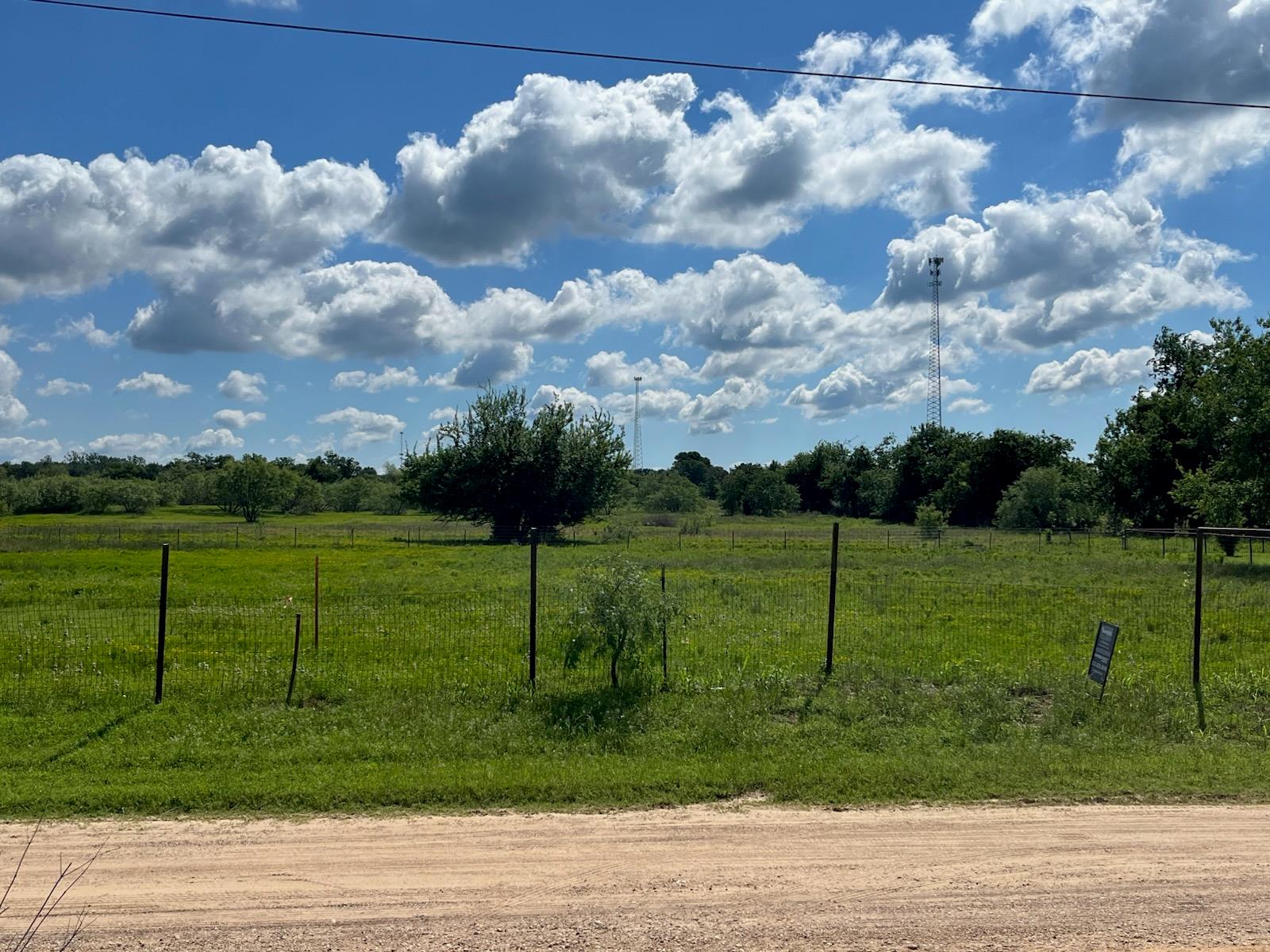 View of yard with fence and a view of rural / pas