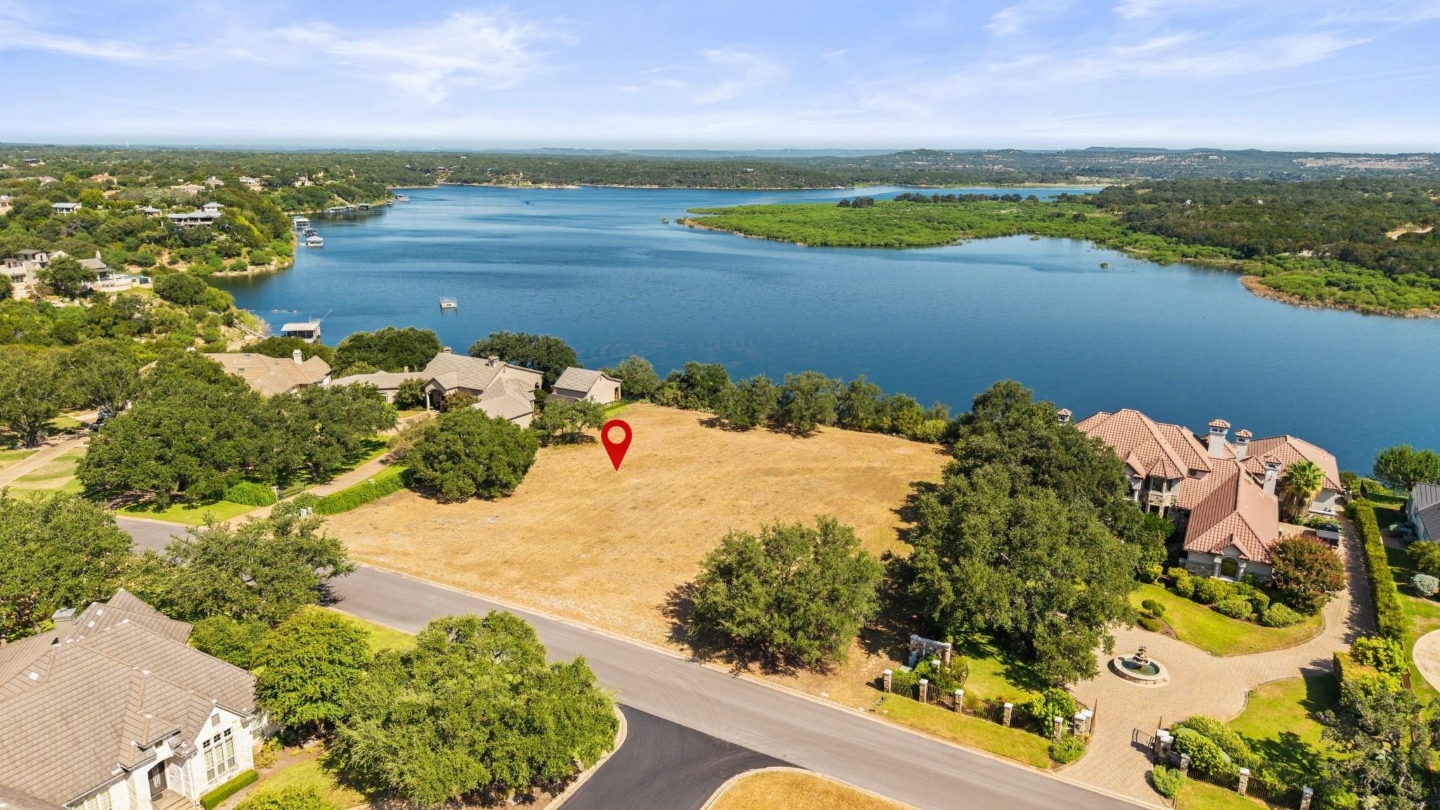 A spacious vacant lot positioned near the calm wa