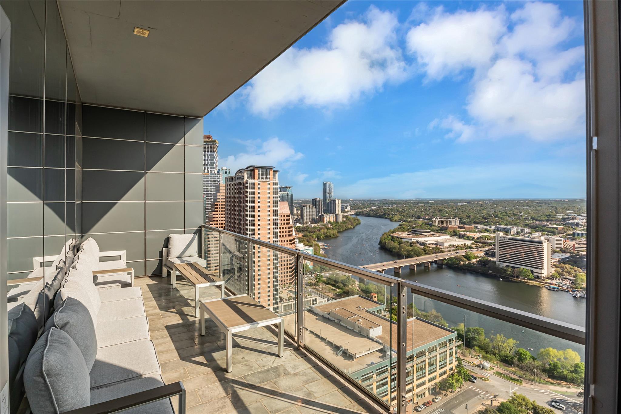 Balcony featuring a water view and a view of city