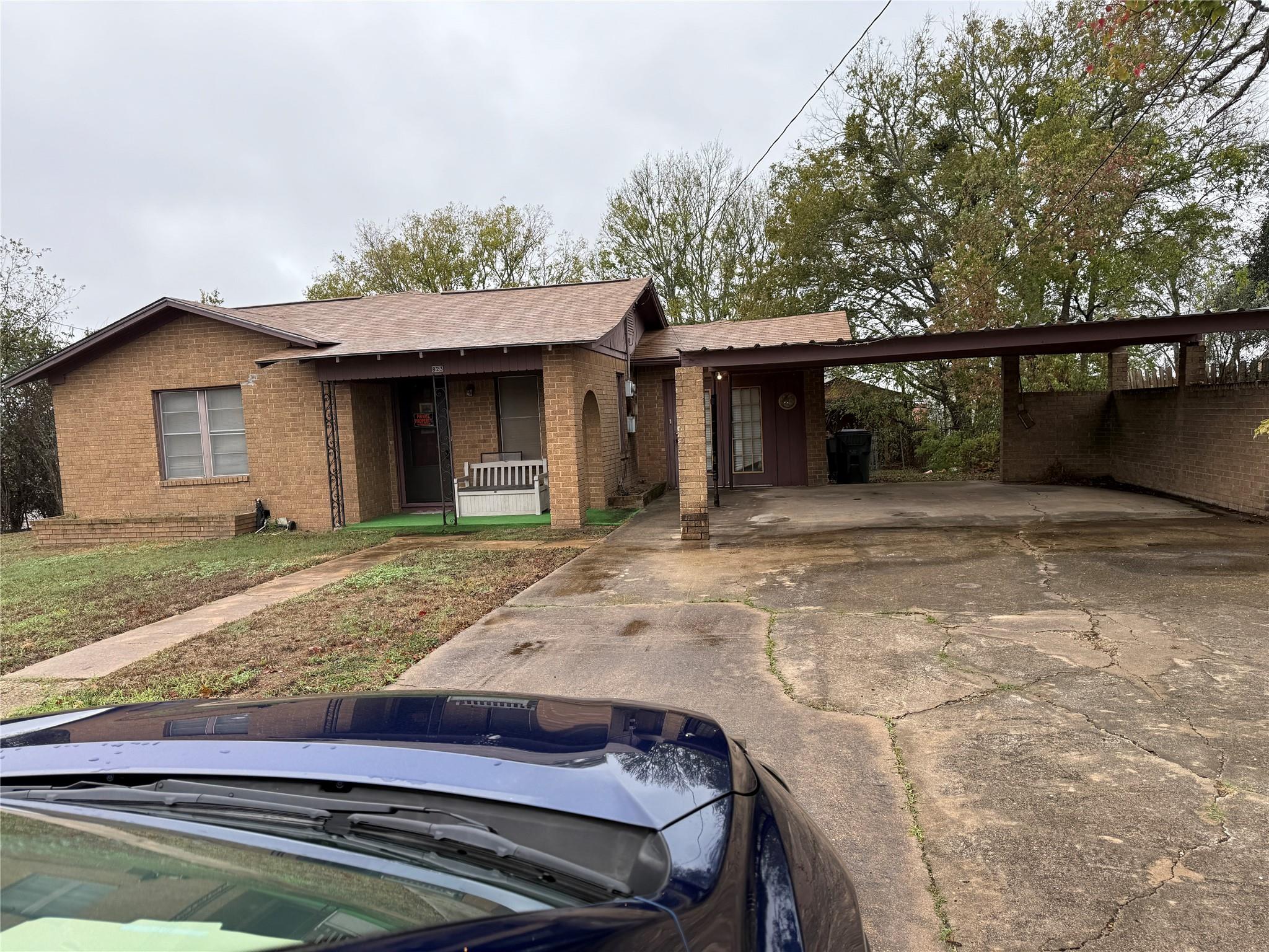 Single story home featuring concrete driveway, br