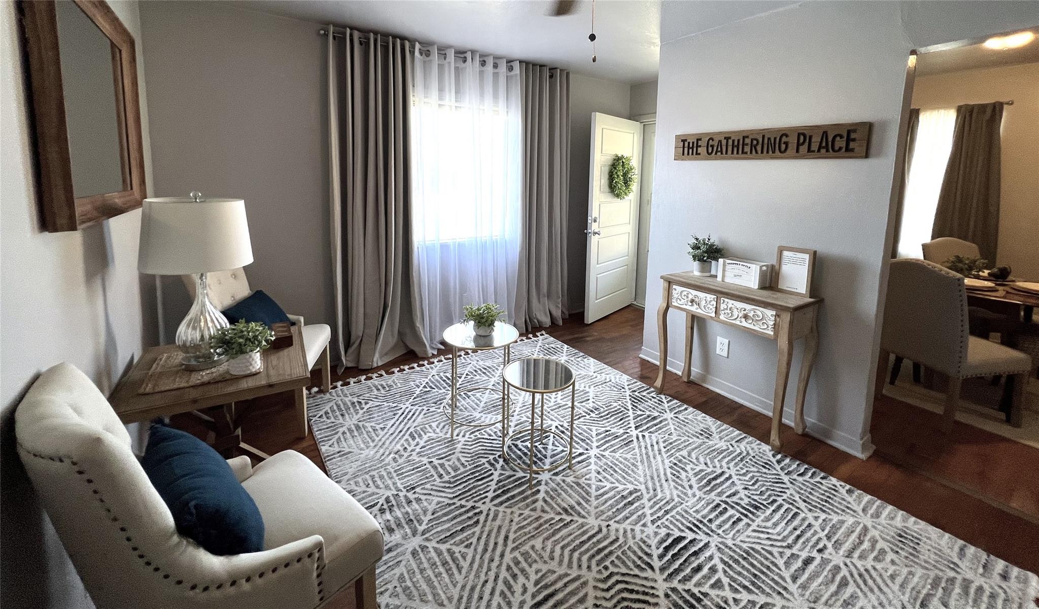 Living room featuring a ceiling fan, baseboards, 