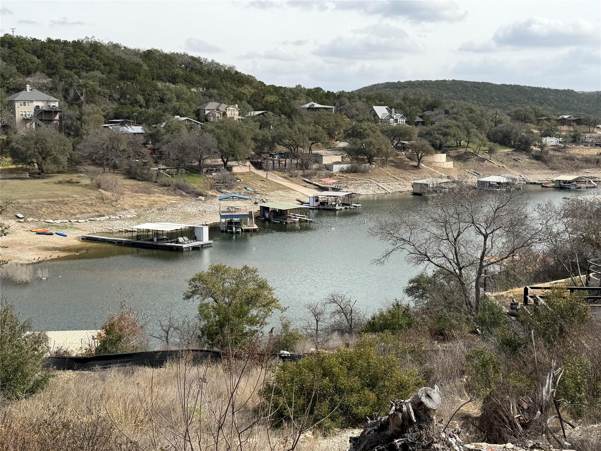 Water view with a boat dock and a heavily wooded 