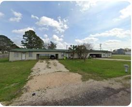 Single story home featuring driveway, a front yar