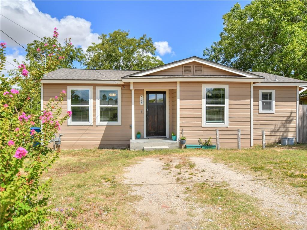 Bungalow-style house with a front lawn