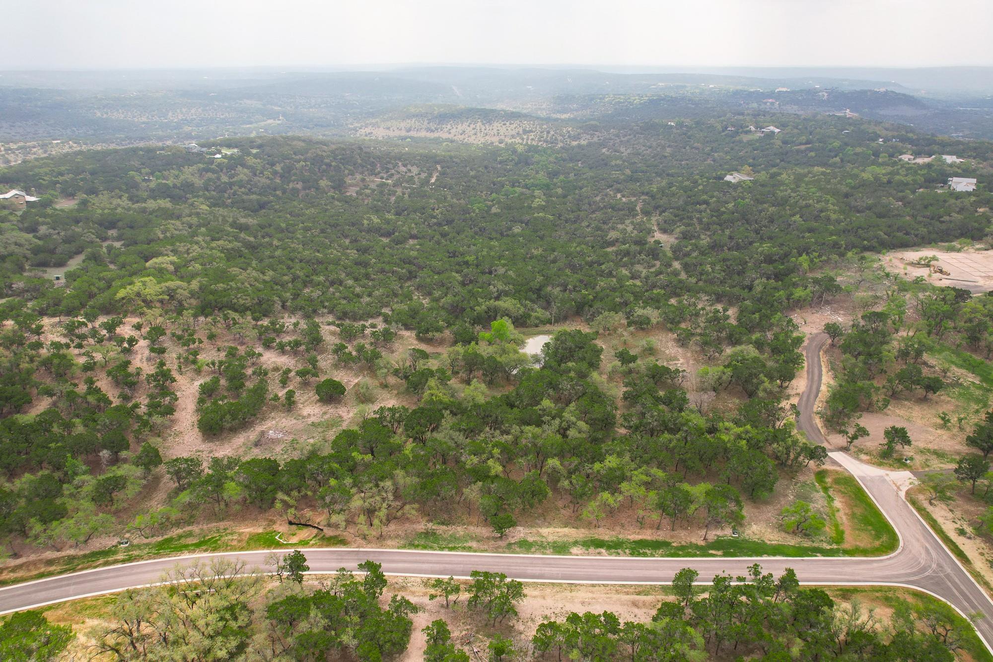 Drone / aerial view featuring a wooded view