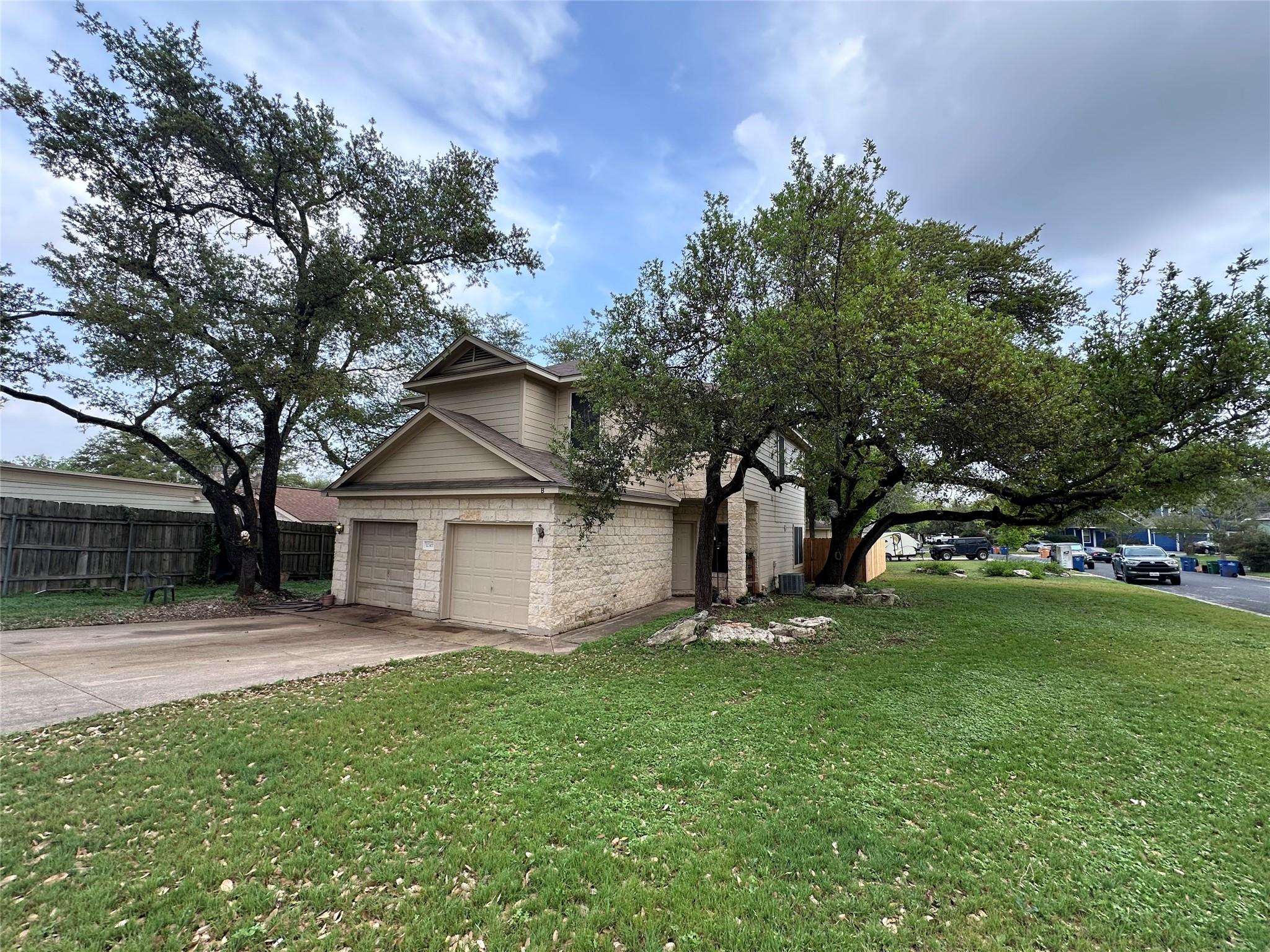 View of front facade featuring concrete driveway,