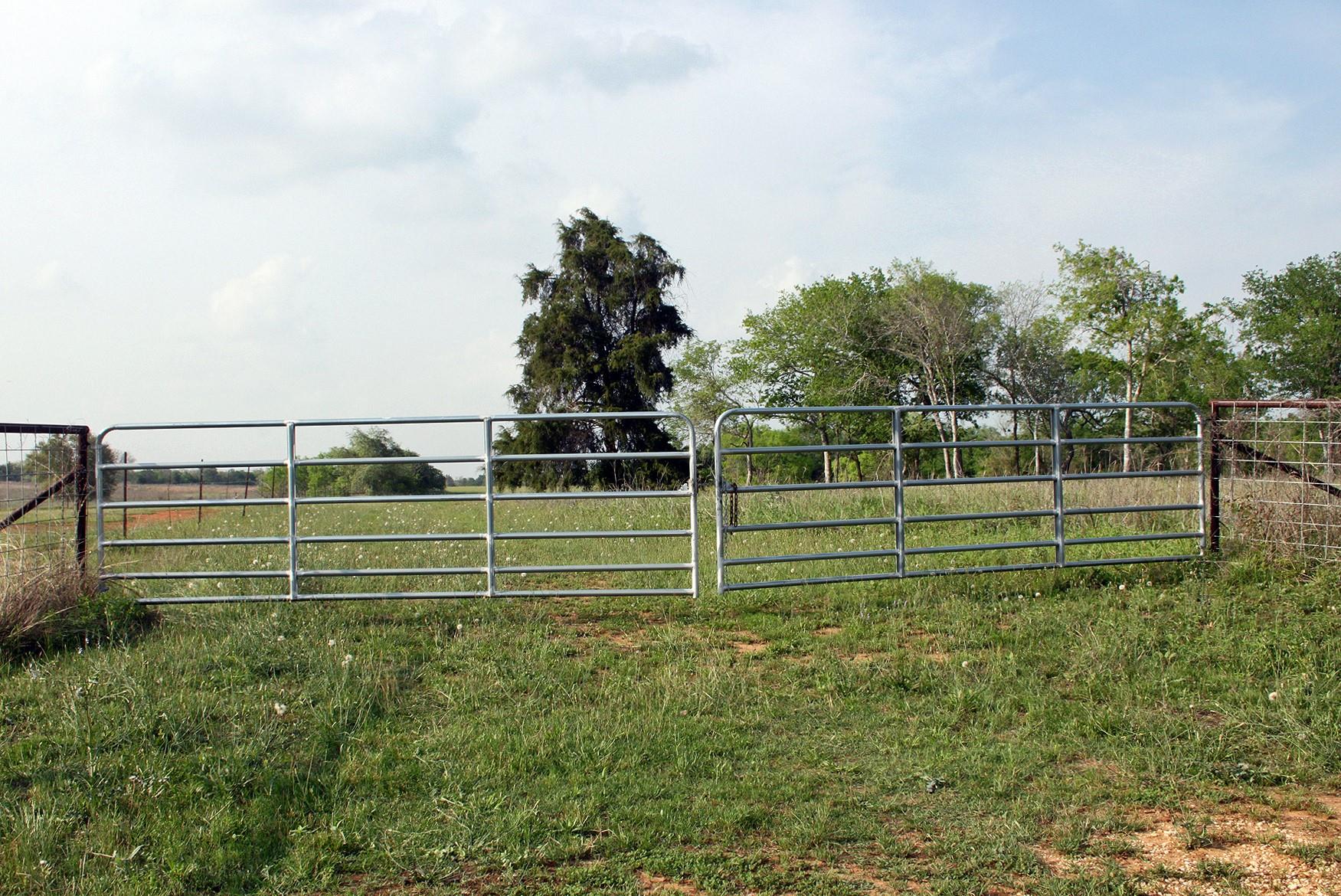 View of yard featuring a gate and fence