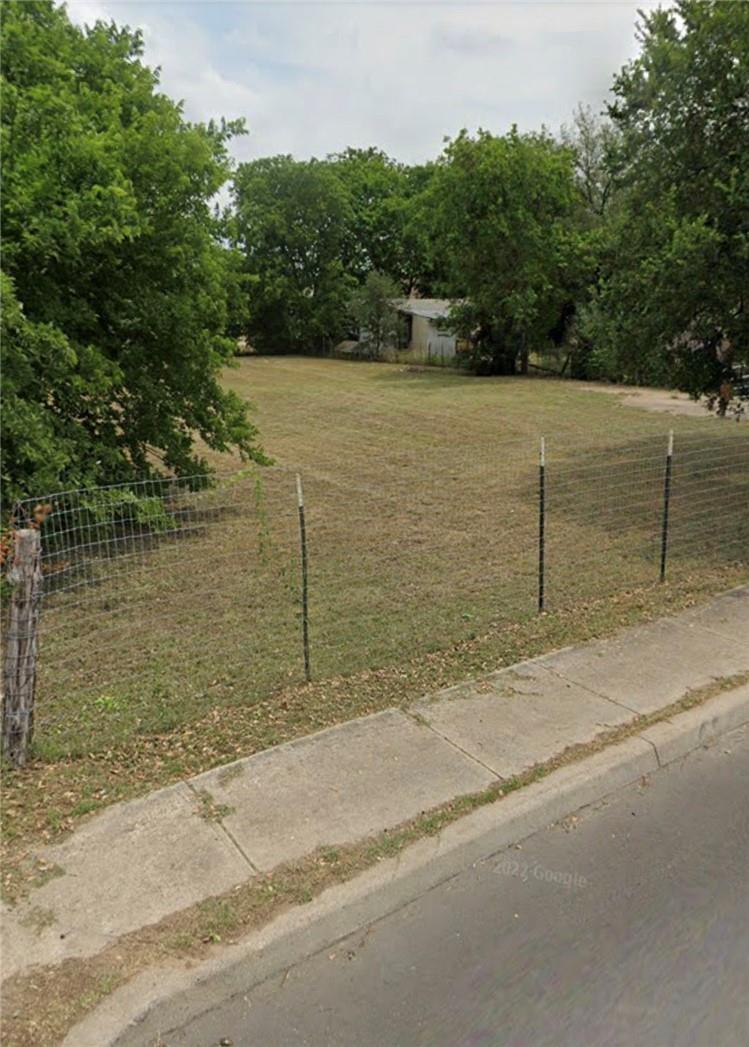 View of yard featuring fence