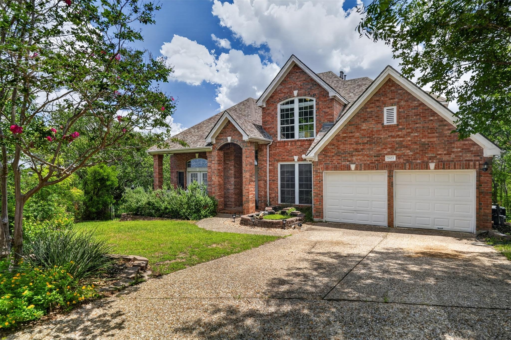 A classic brick exterior, arched entryway, and du
