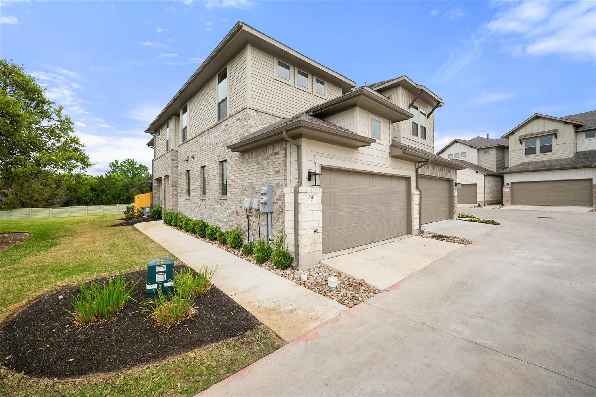 View of property exterior with driveway, an attac