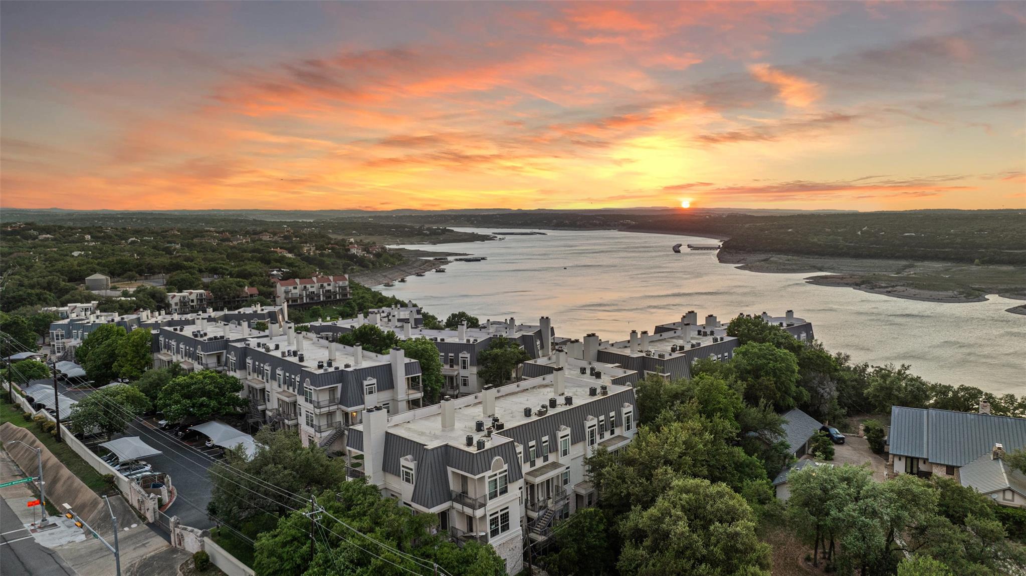 Aerial view at dusk featuring a water view