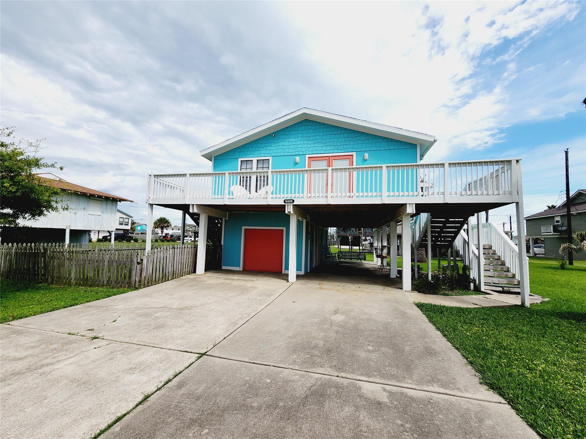 Coastal inspired home with a carport, concrete dr