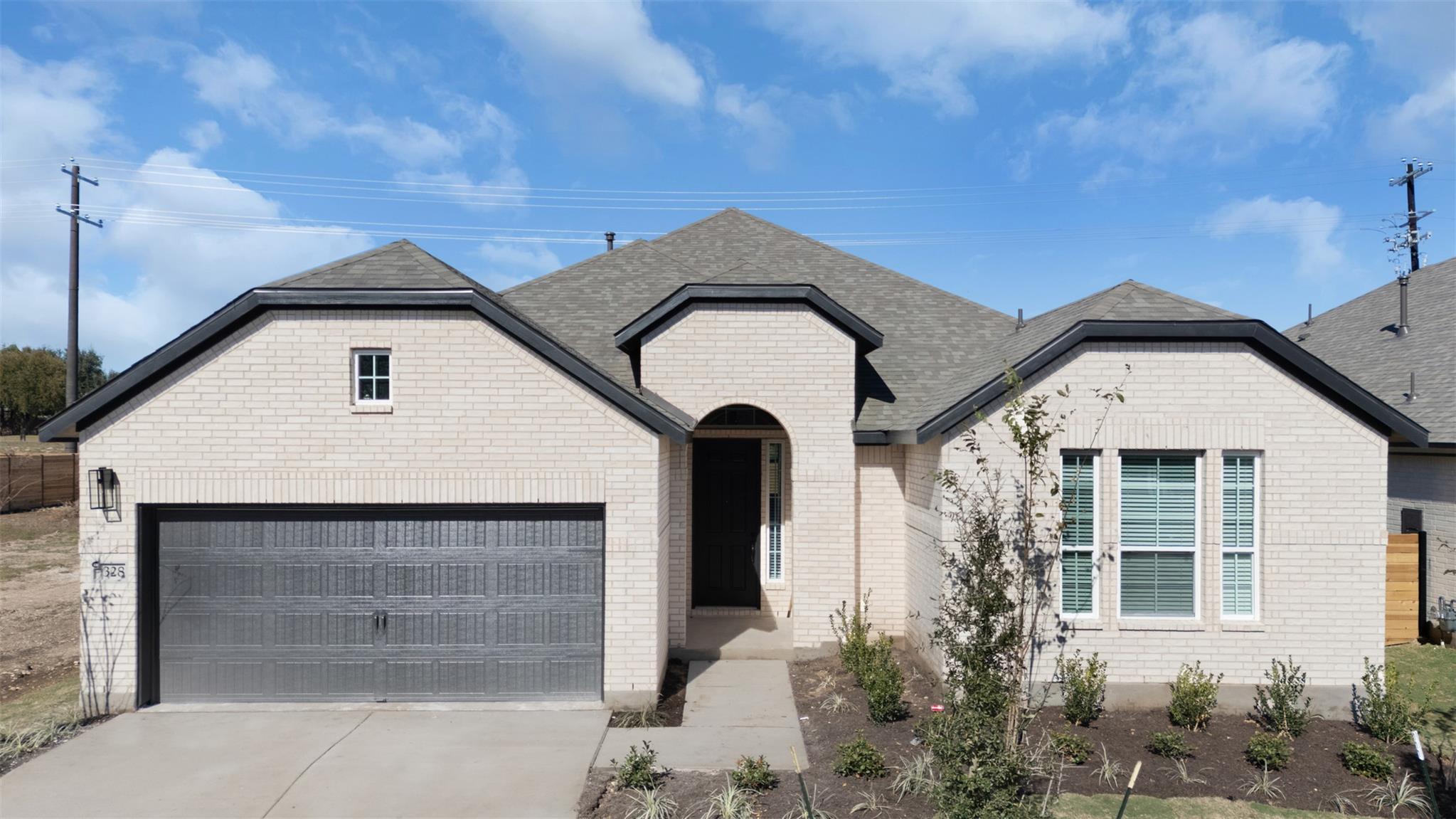 View of front of house with driveway, a garage, r