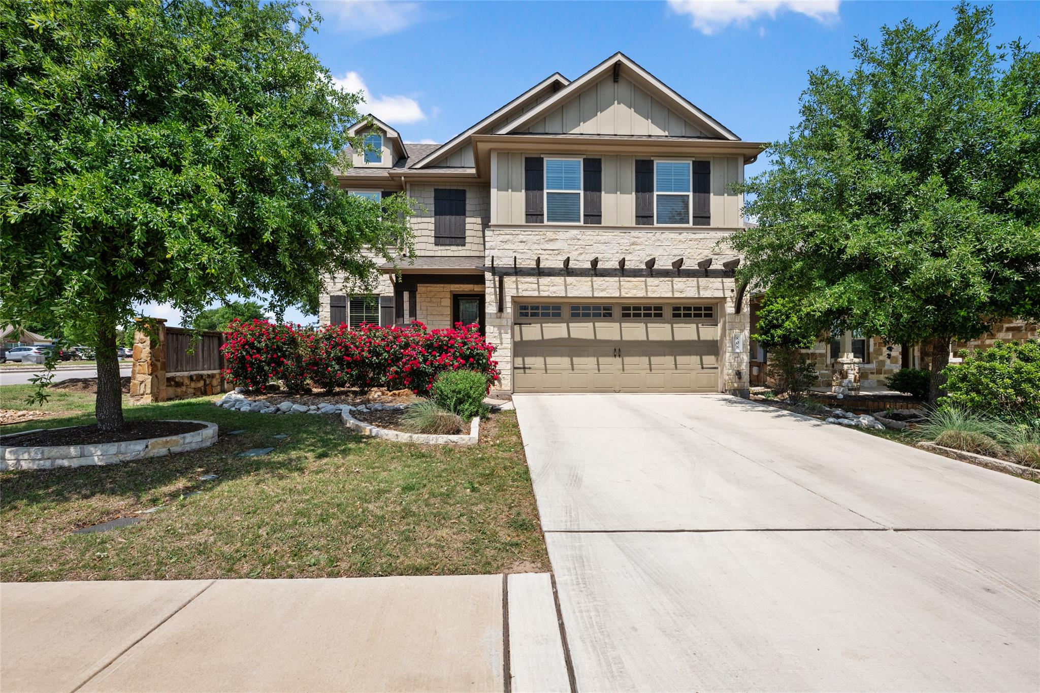 Craftsman inspired home with stone siding, a gara