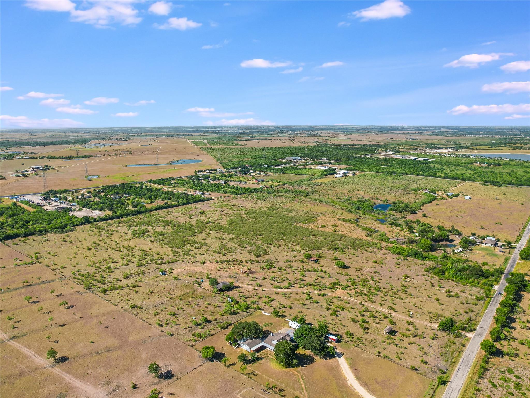 Birds eye view of property with a rural view