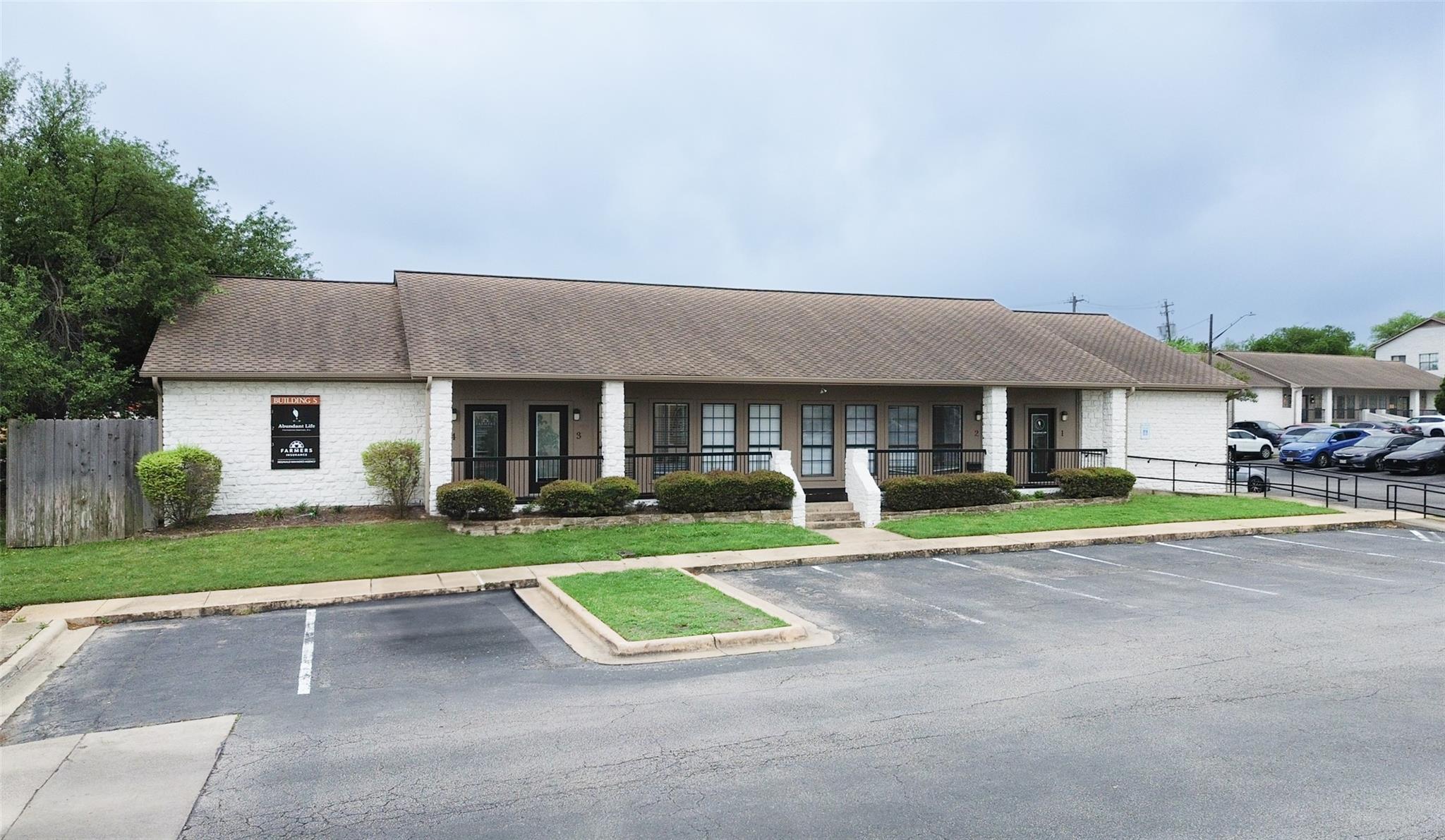 View of property featuring uncovered parking and 