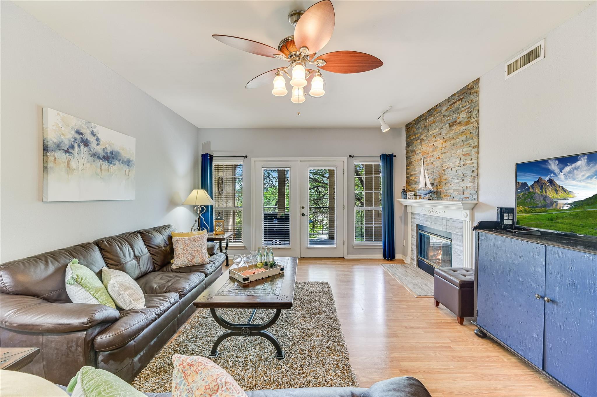 Living area with a tile fireplace, visible vents,
