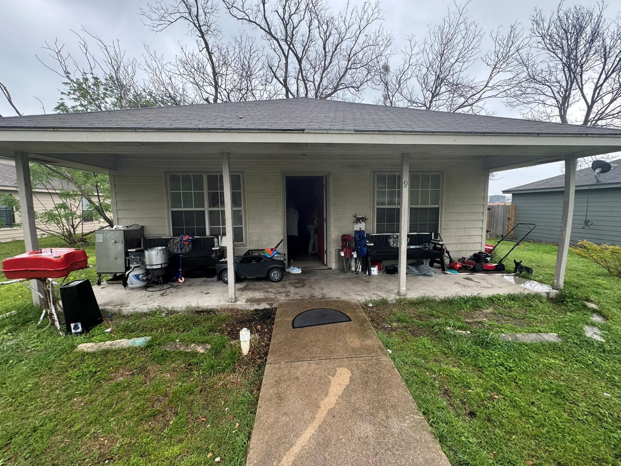 Back of house featuring a yard and a shingled roof