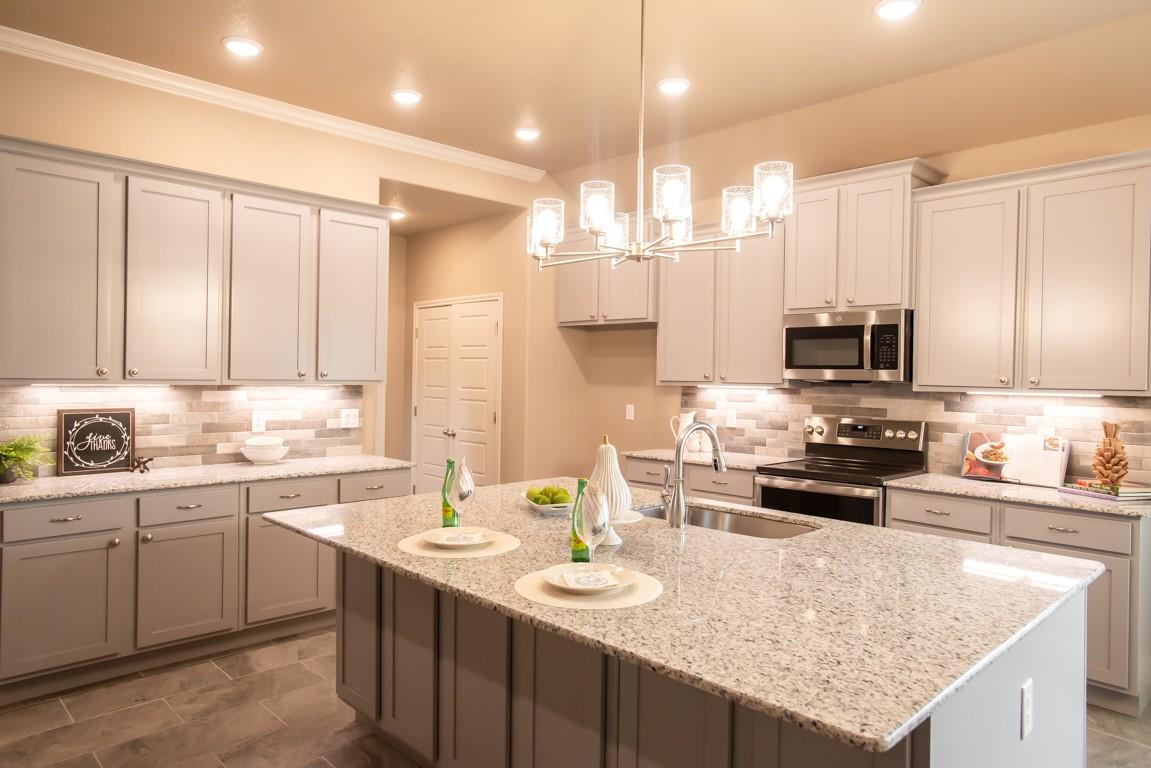 Kitchen featuring a notable chandelier, appliance