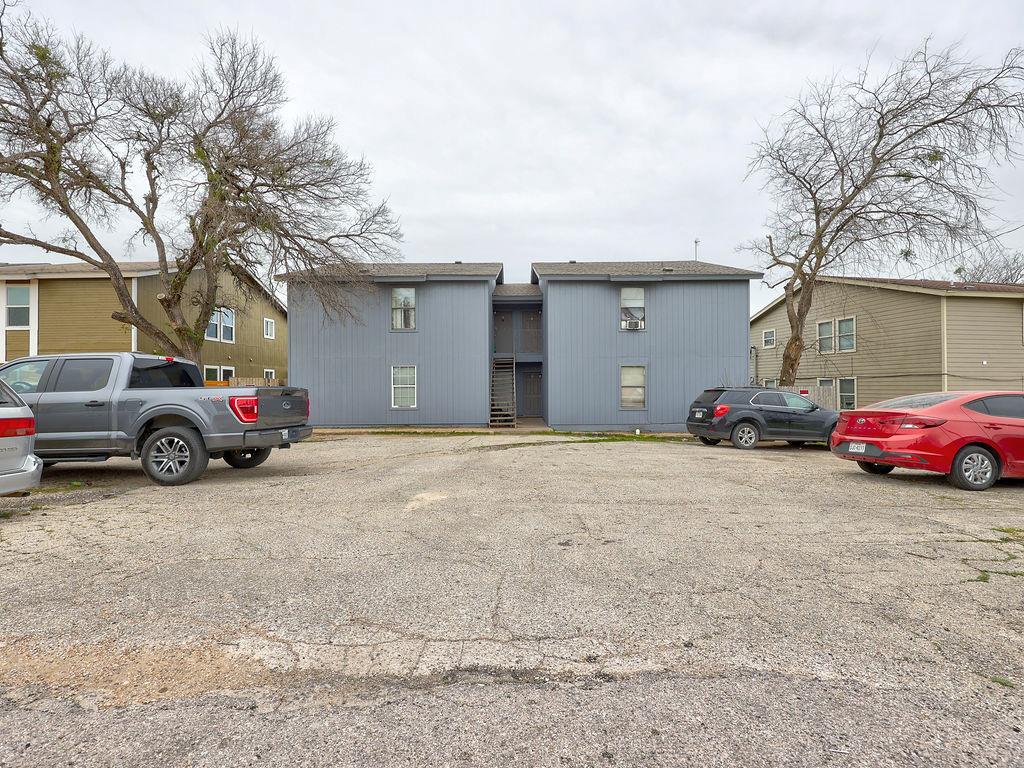 View of property with uncovered parking