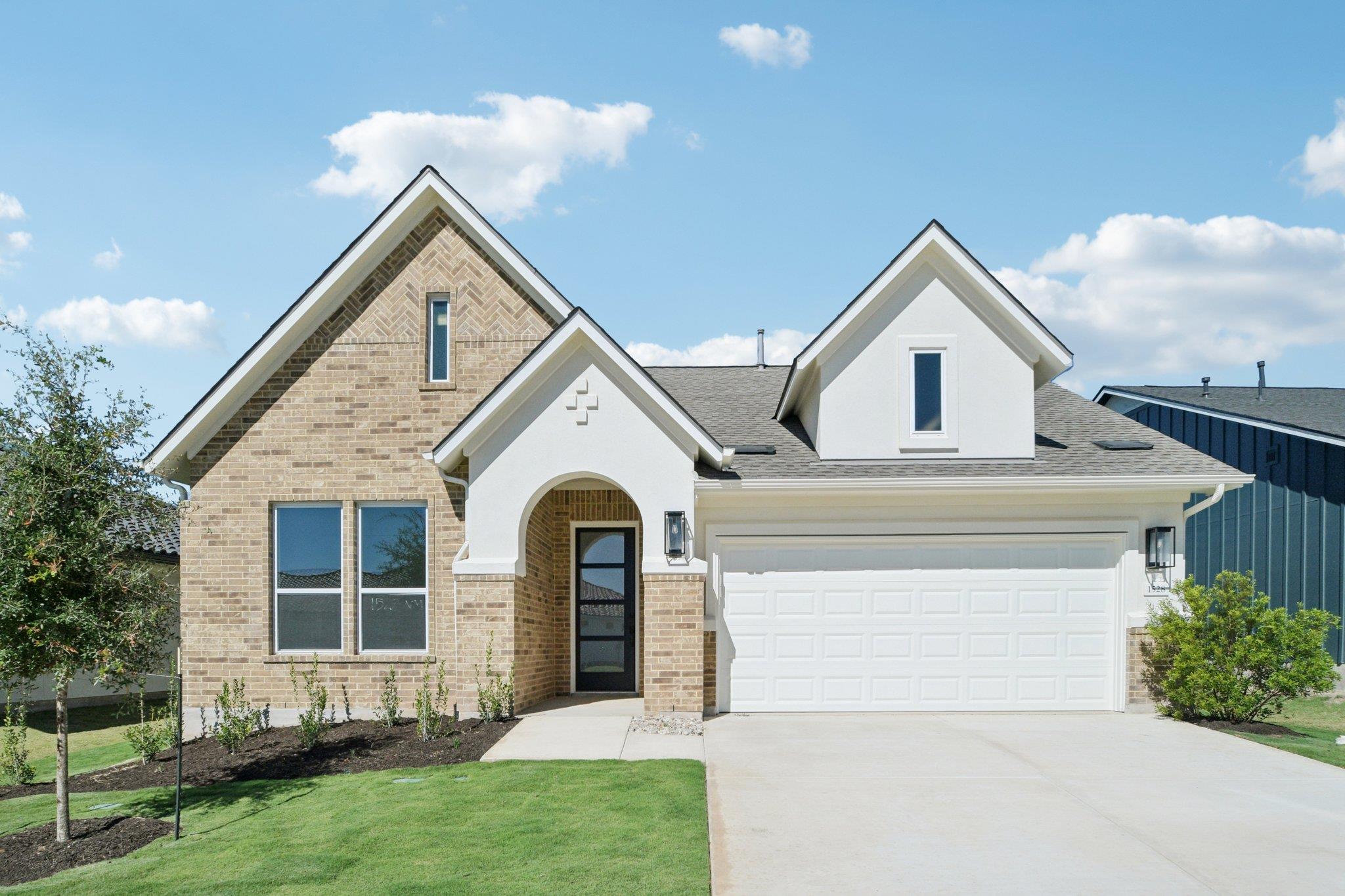 View of front of property with a garage, driveway
