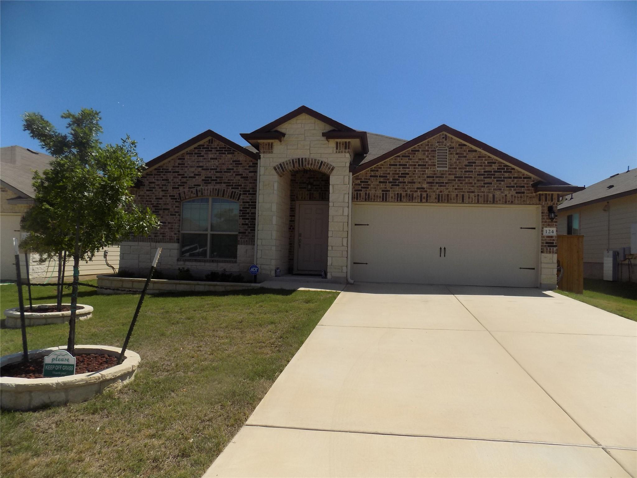View of front of house with brick siding, a garag