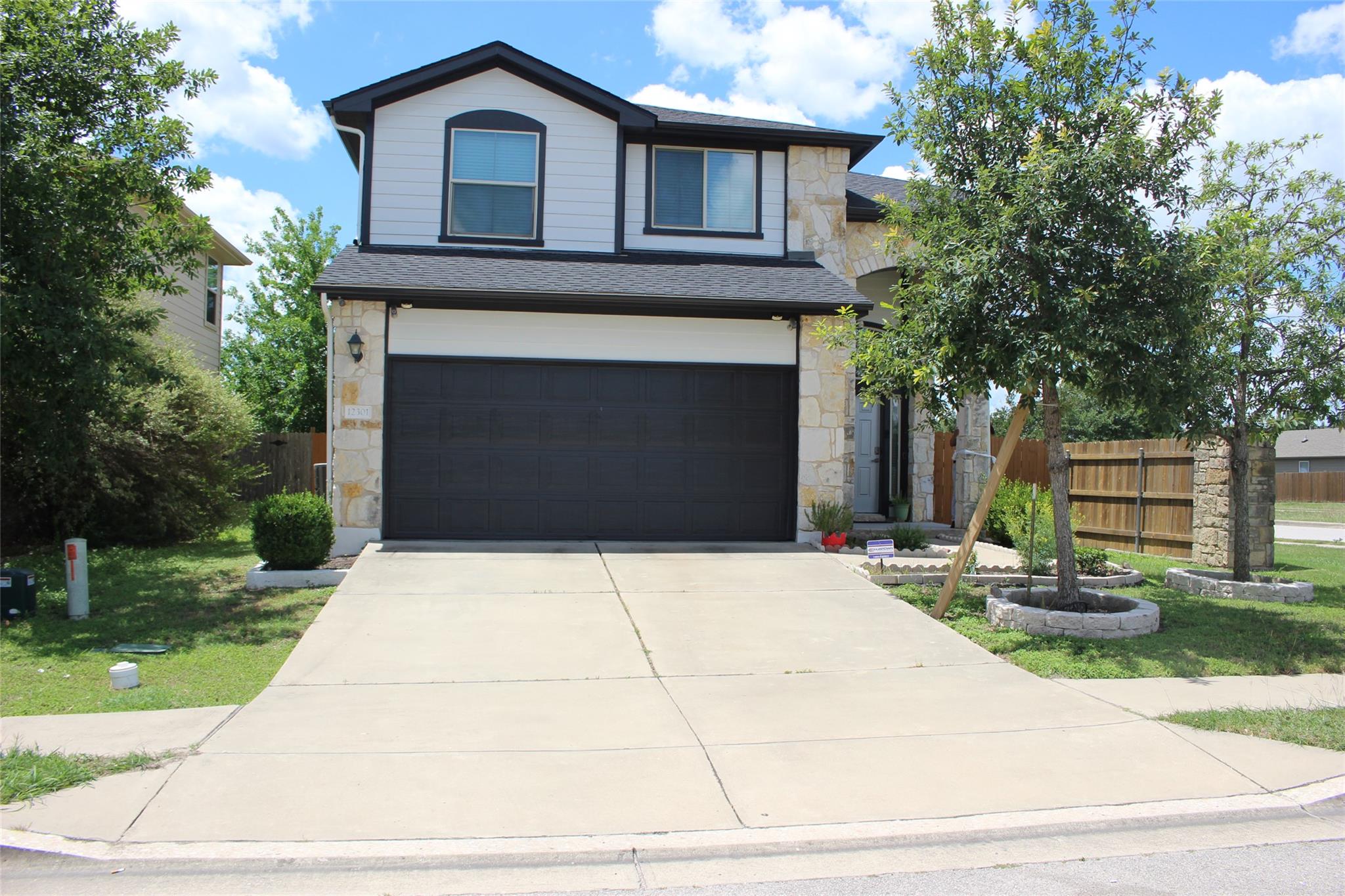 View of front of home with stone siding, concrete
