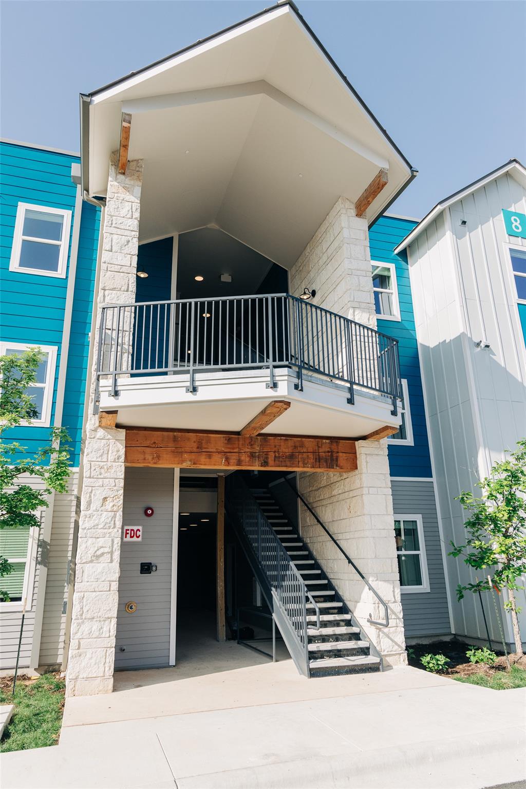 View of front of house featuring a balcony, drive