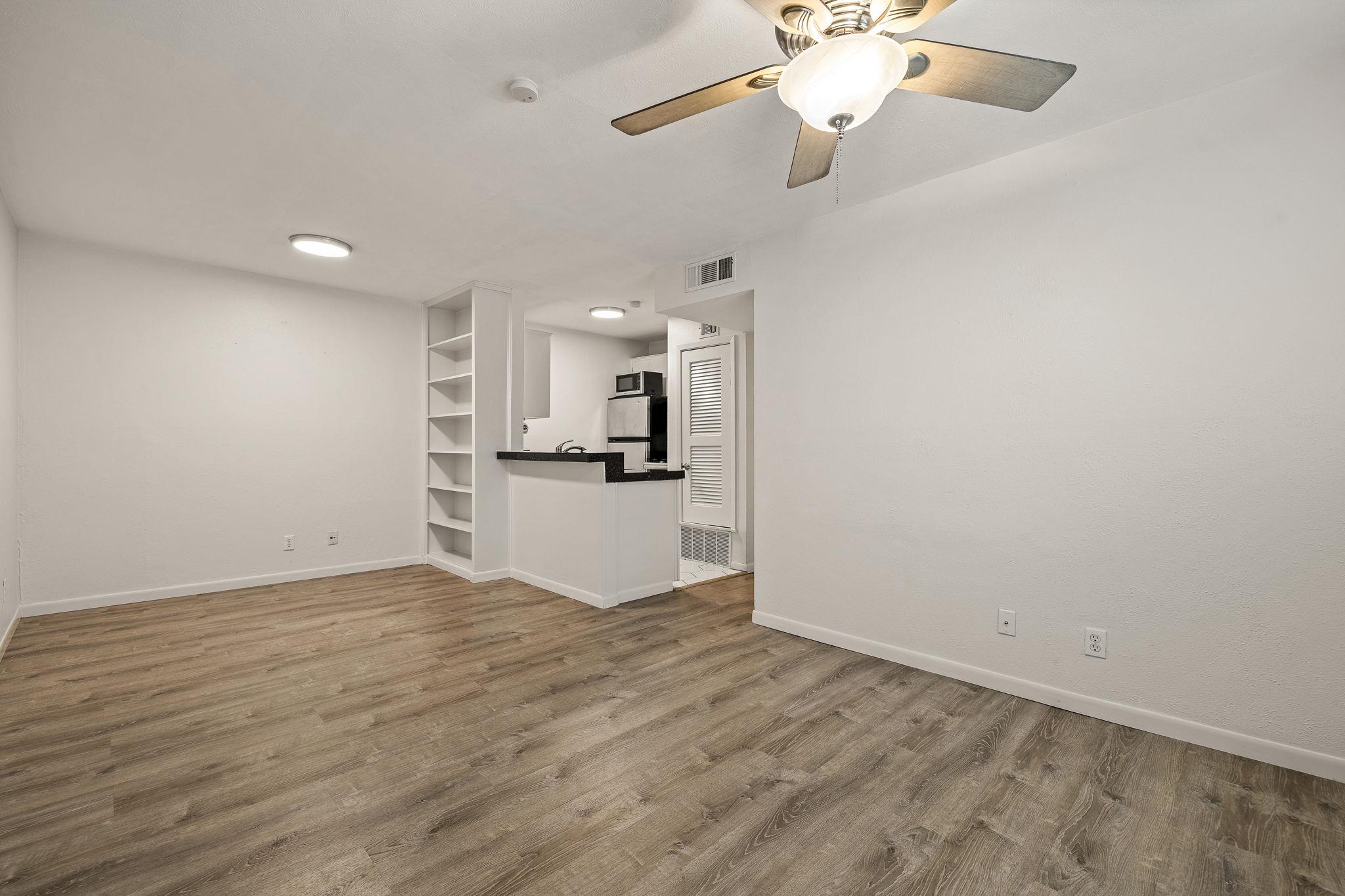 Unfurnished living room with wood finished floors