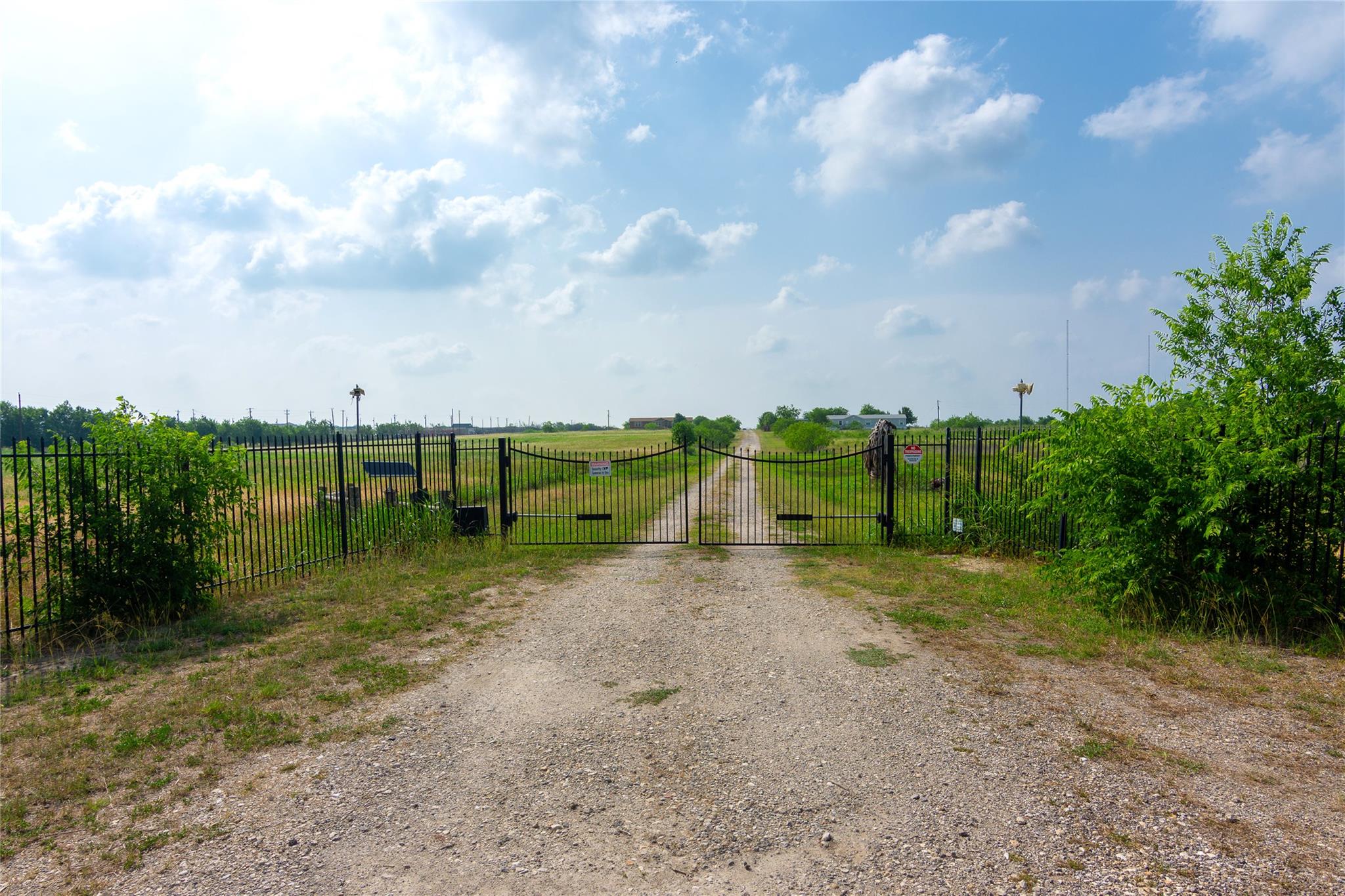 View of road featuring a gate, a rural view, and 