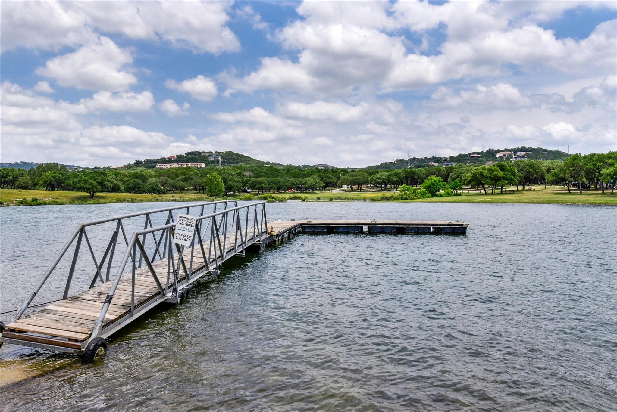 Dock area with a water view and view of scattered