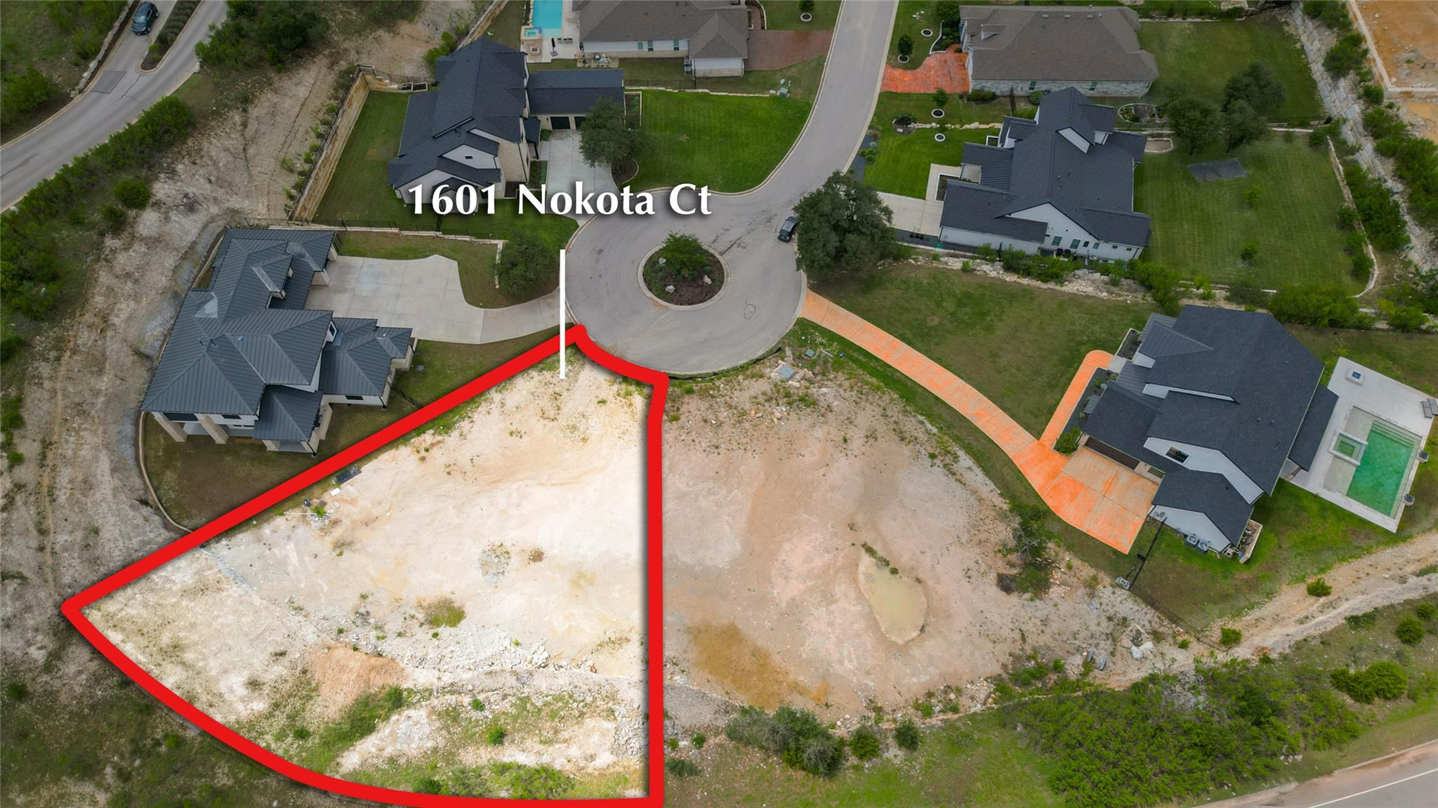 Aerial view of residential area with property par