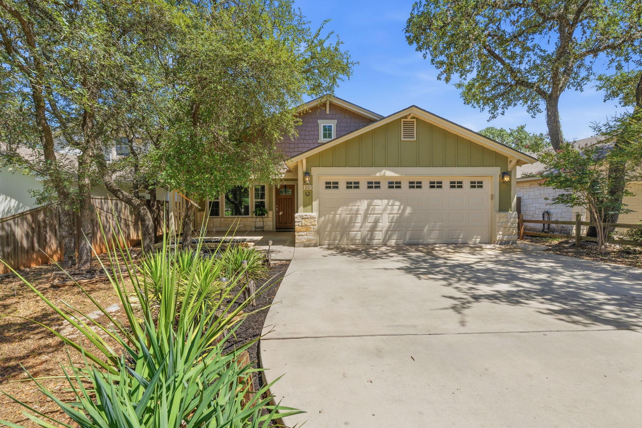 A welcoming facade with a spacious driveway, ston