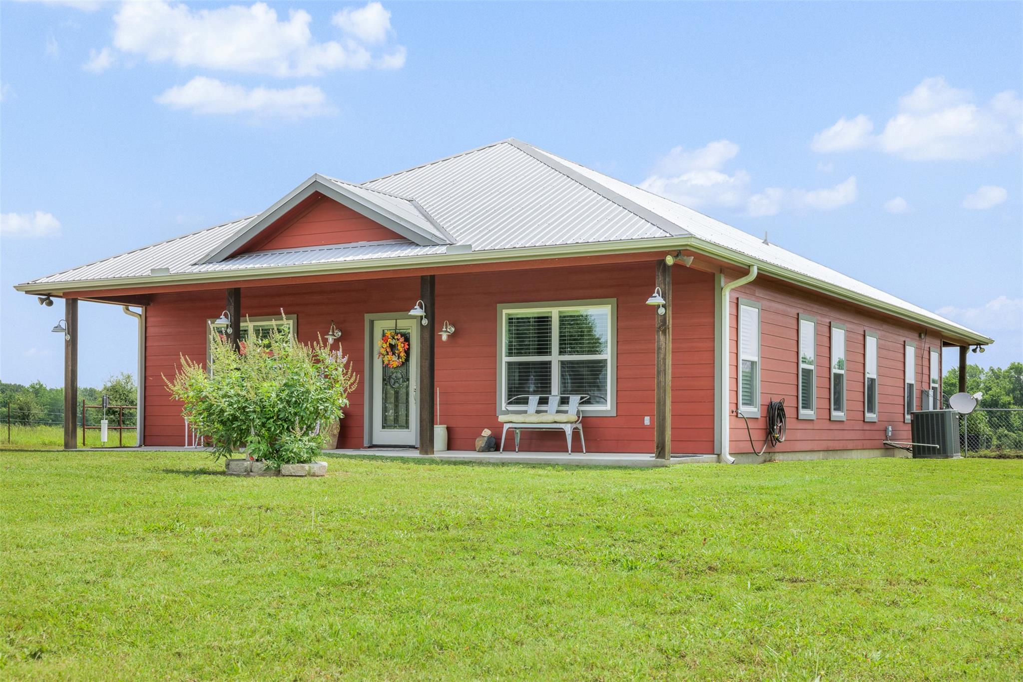 View of front of house with a front yard, covered