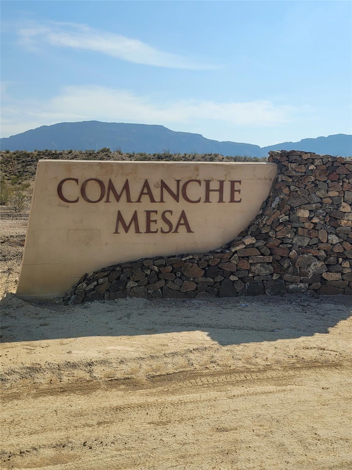 Community / neighborhood sign featuring a mountai