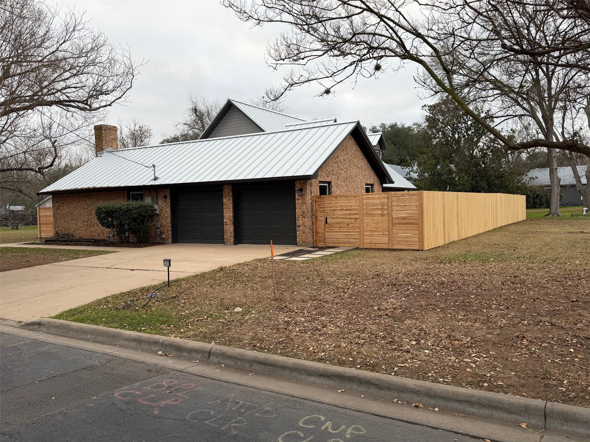 View of home's exterior featuring a chimney, bric