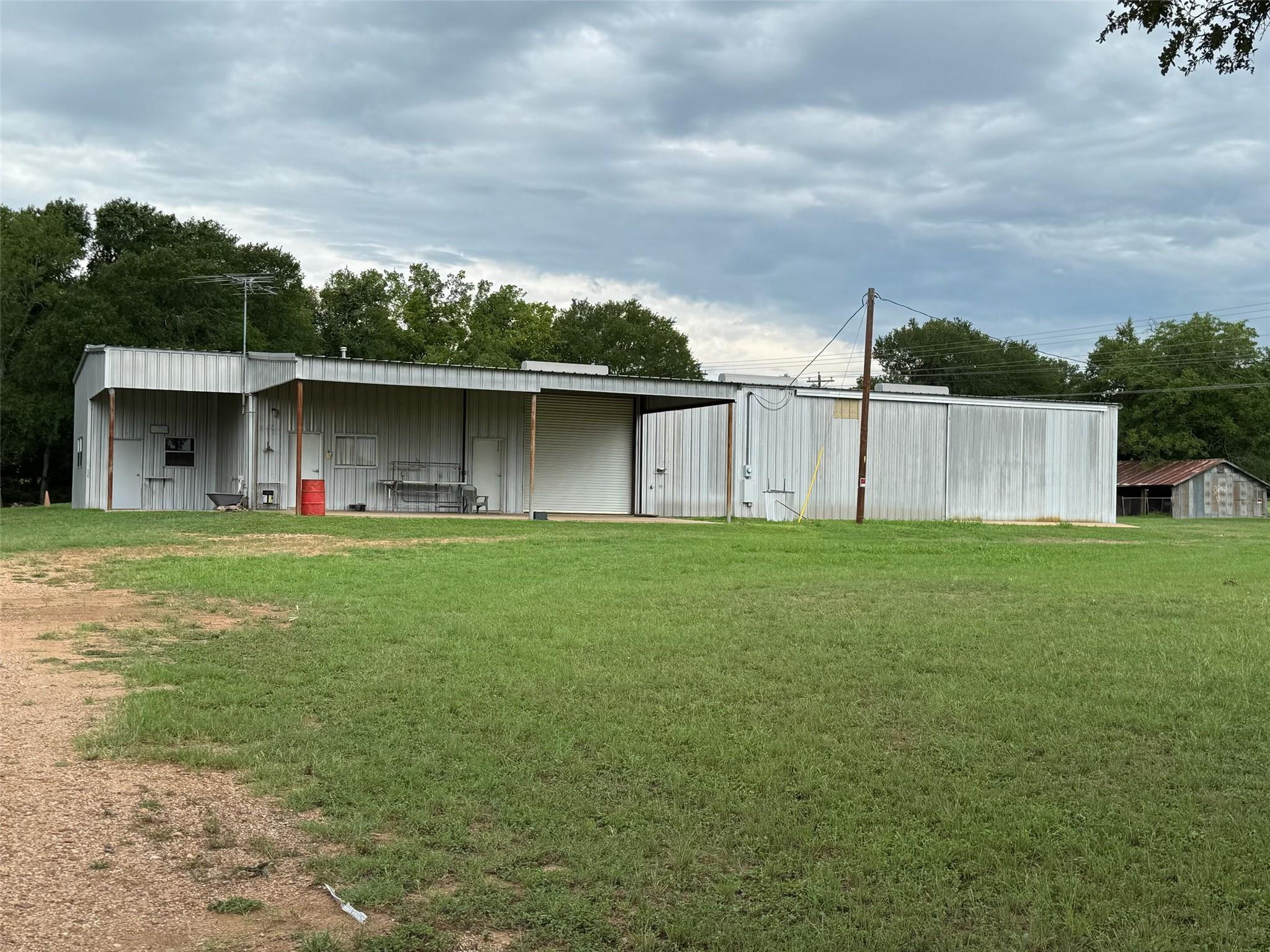 View of pole building featuring a lawn