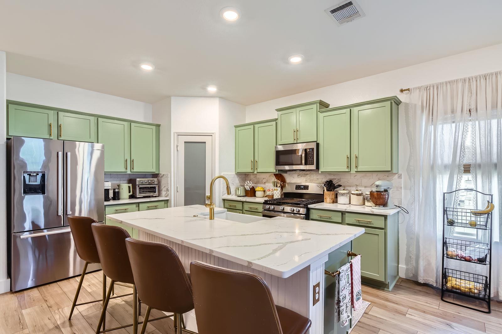 Kitchen with stainless steel appliances, green ca