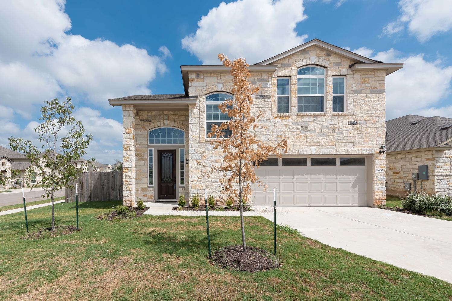 A cream-colored stone facade and inviting arched 