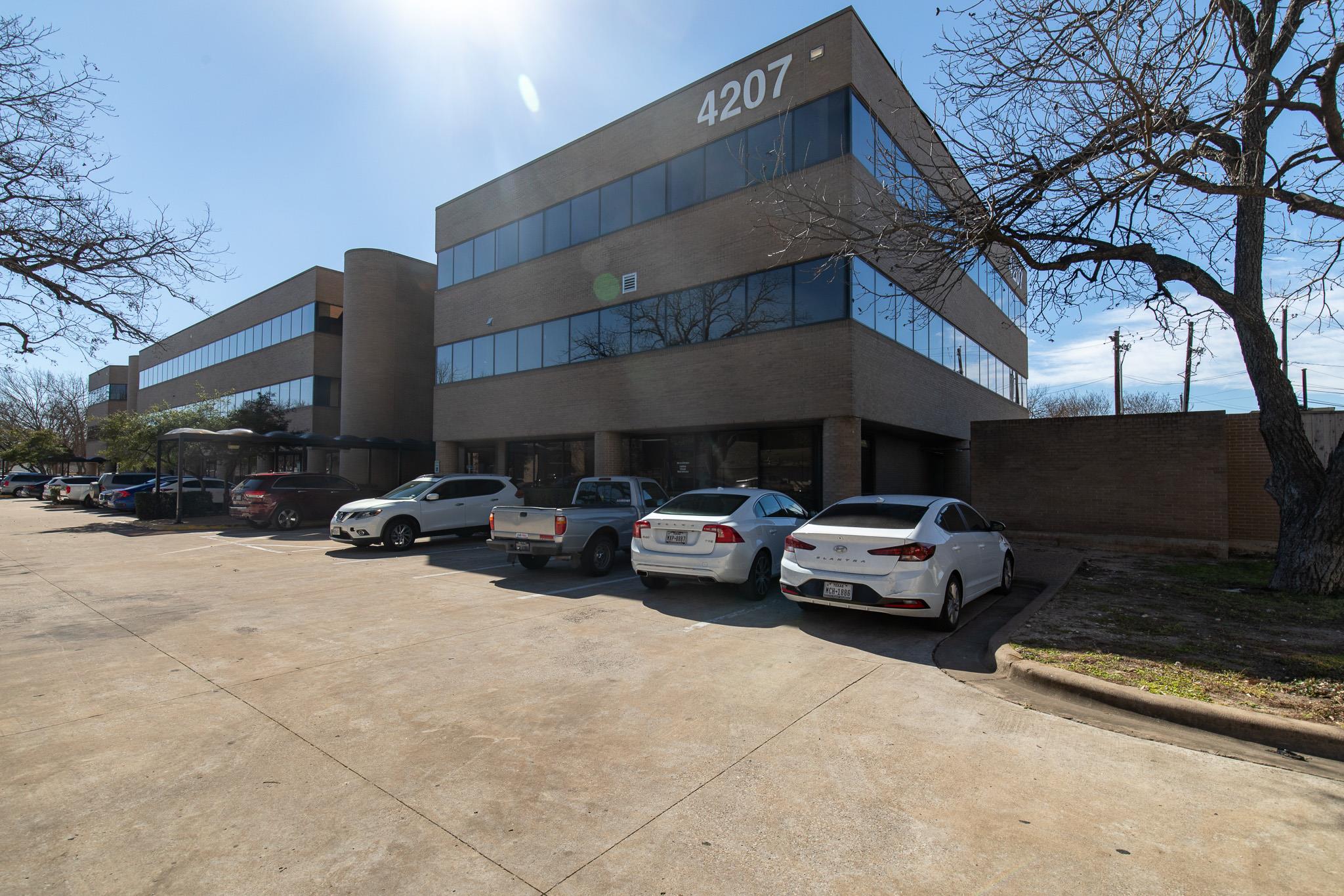 View of property with uncovered parking
