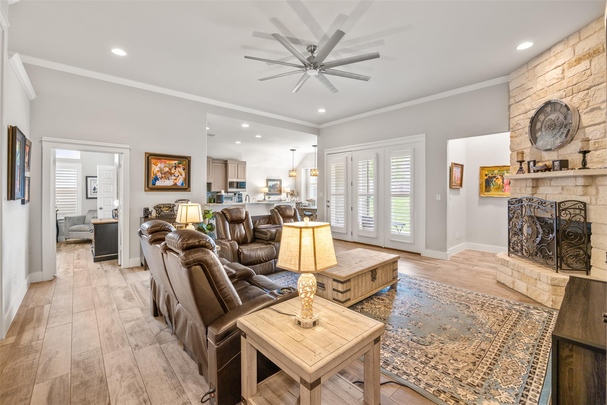 Living area with ceiling fan, ornamental molding,