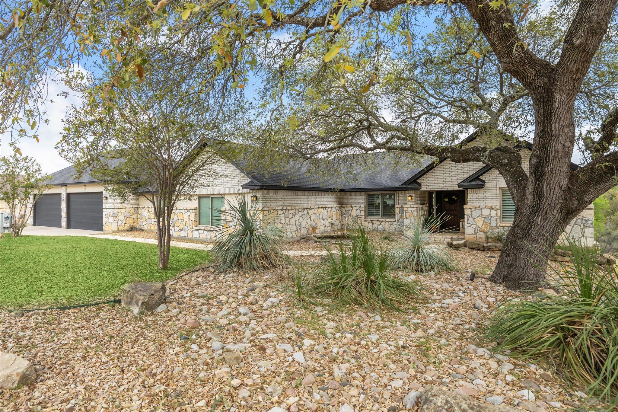 View of front of property featuring stone siding,